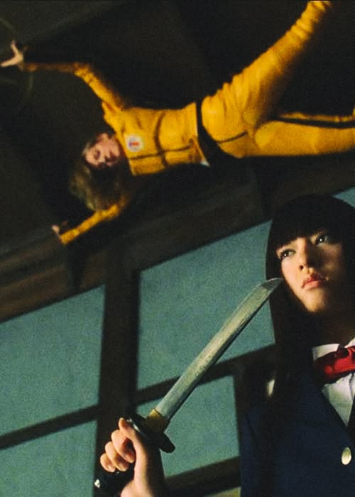 Elle Driver holds a sword in the foreground as the Bride in yellow is seen above her.