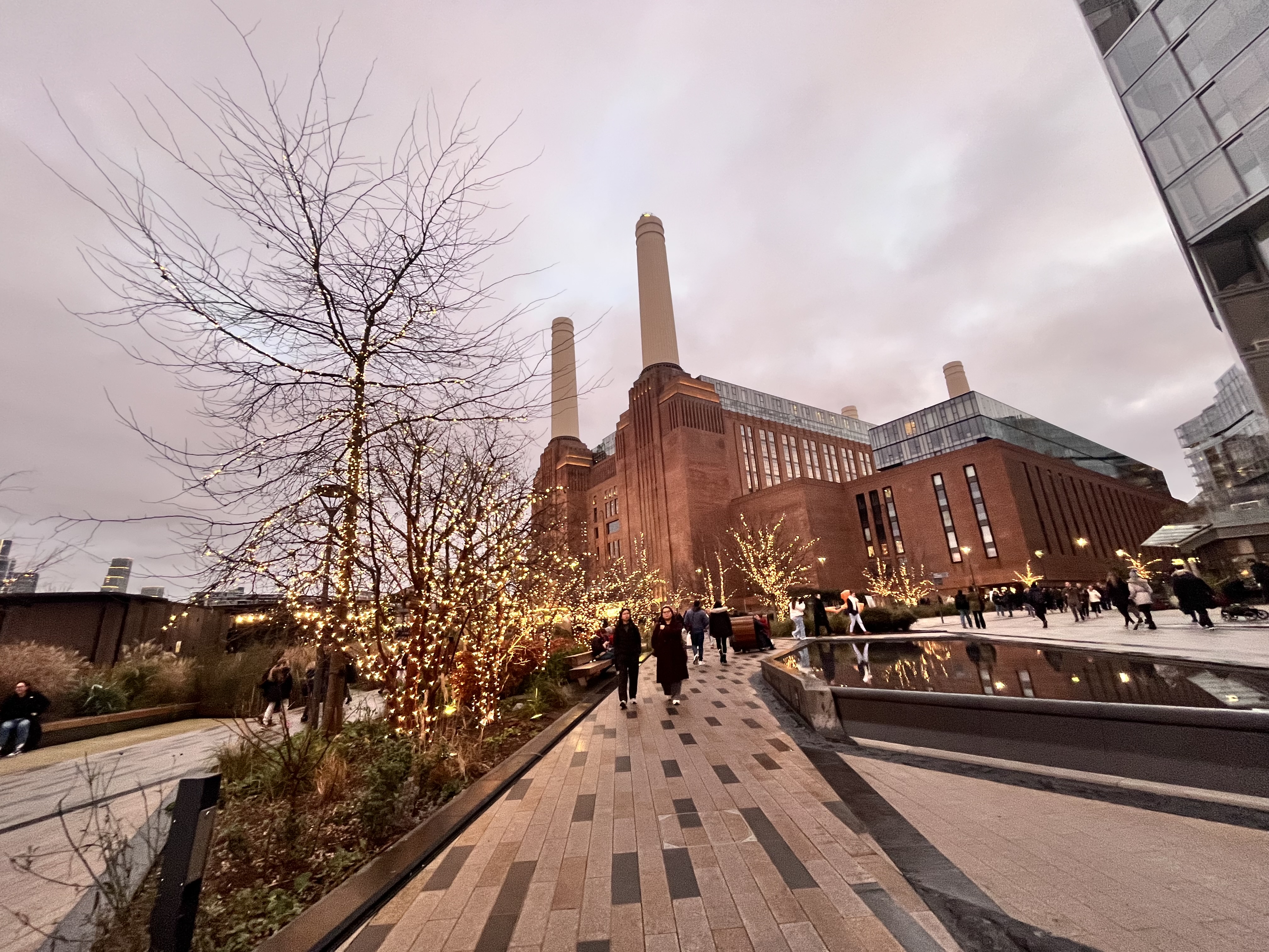 A brick power station and trees wrapped in lights, from Ilyas’s camera roll