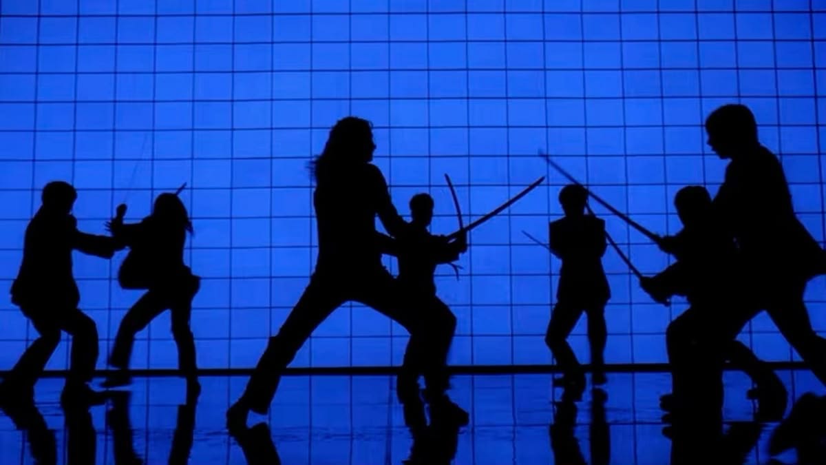 Sword fighters silhouetted against a blue tiled wall.